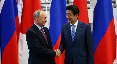 vladimir putin suggests signing a peace treaty to japanese pm shinzo abe