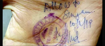 kashmiri man s hand signed and stamped to allow him to cross the road