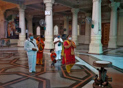 worshippers in masks visit temples as india reopens amid rising covid 19 cases