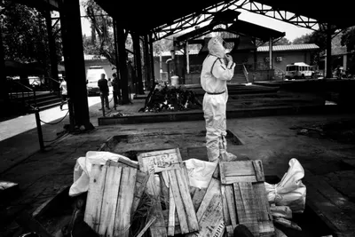 in photos  of cremations  hazmat suits and ‘respectful funerals’