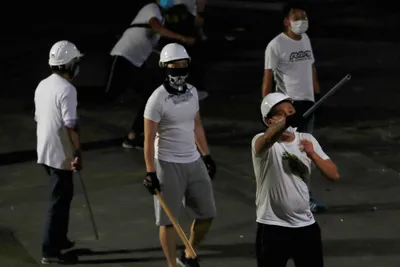 hong kong  masked men in white shirts attack protestors with sticks
