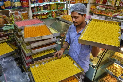 inflation squeezes multiple sectors  sweet prices rise in festive season  fmcg hit too  rural wage growth slows down