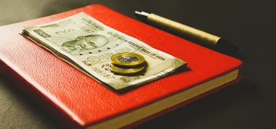 amid pressure from yuan decline and dollar rally  rupee closes at record low of 85 77  report